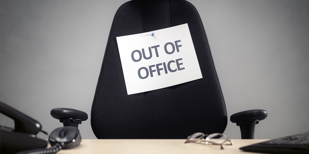 Empty office chair with sign that says Out of Office