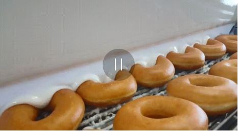 Image of donuts getting covered in icing